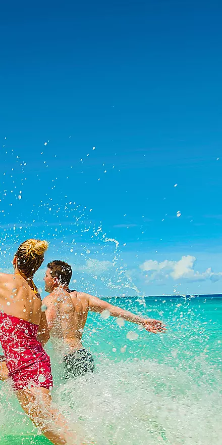 Eastern Caribbean cruise ship docked at tropical island port with turquoise waters, white sandy beaches, and vibrant local culture