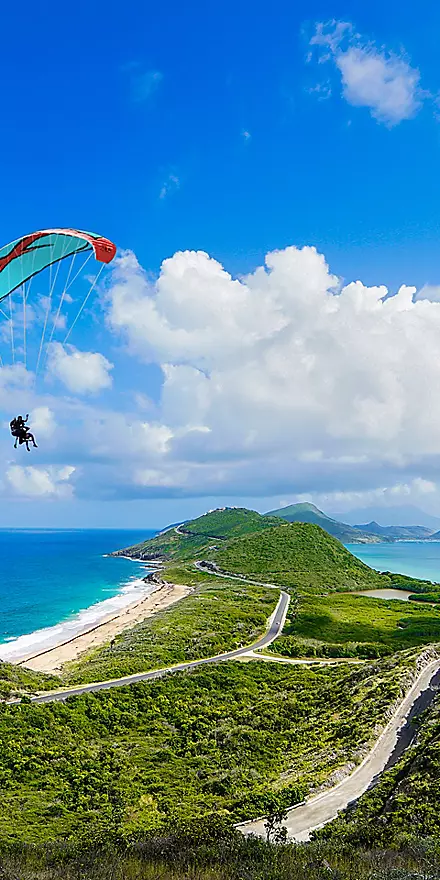 Southern Caribbean cruise ship sailing to tropical islands with crystal-clear waters, white sandy beaches, and lush green landscapes